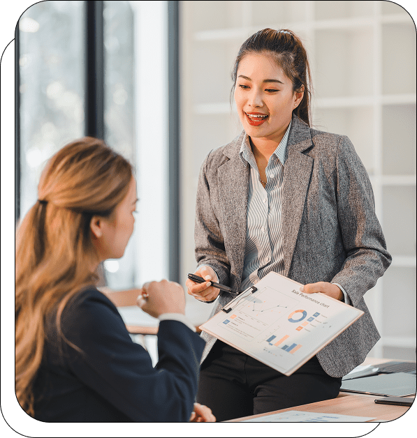 Two businesswomen discussing a financial report.