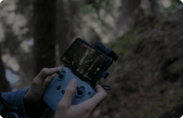 Person operating a drone with remote controller.