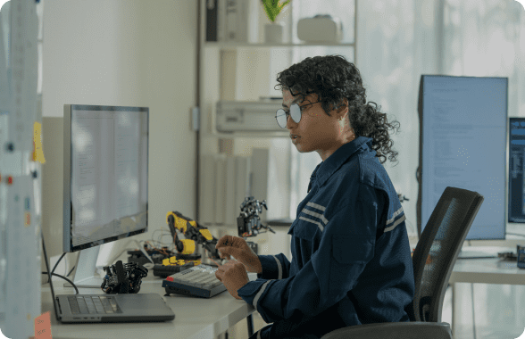 Person working at a computer desk.